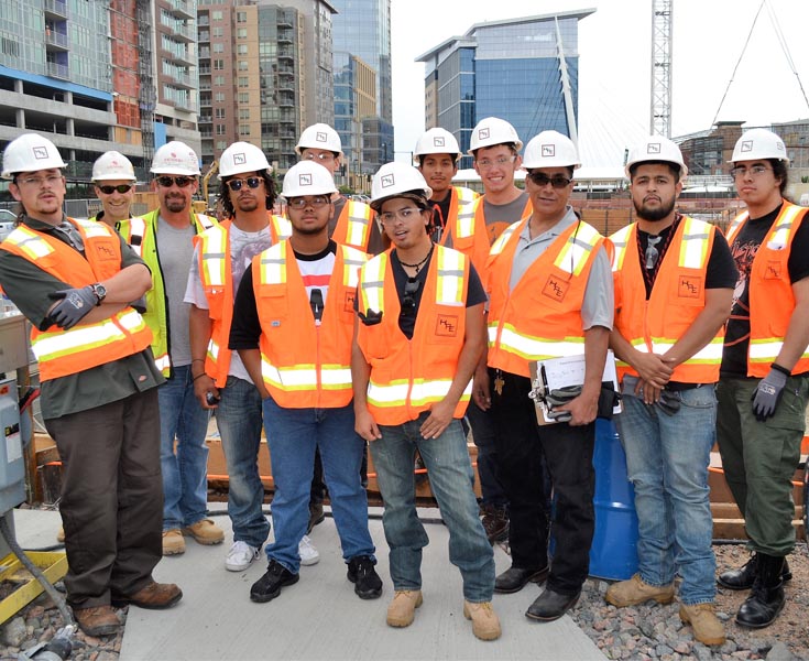 Group of construction workers on a job site learning trade skills