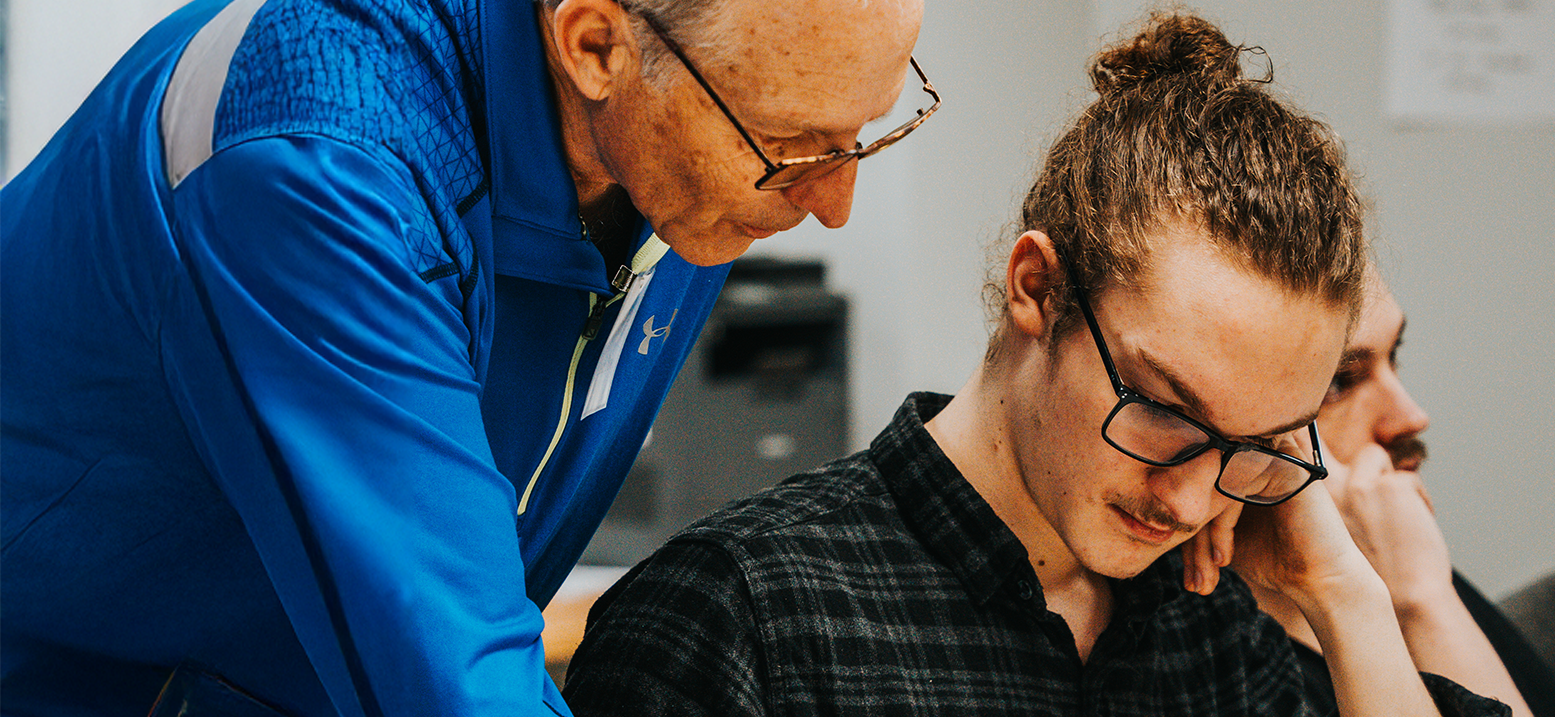 A coach helping a student